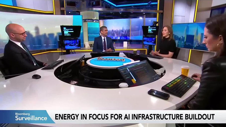 Bloomberg correspondents and Raj Agrawal sit at a table discussing KKR's infrastructure outlook,